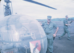 image vas009244, color picture of US soldiers in front of a helicopter in the field. Click for more information
